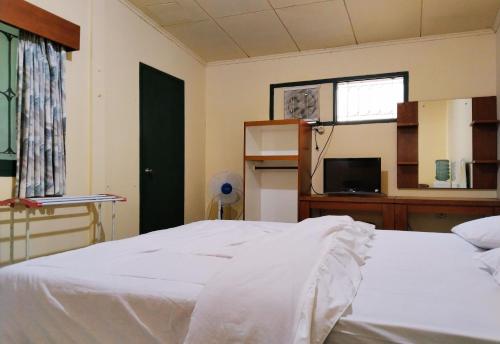 a bedroom with a white bed and a window at Hotel Grand Astoeti in Kopo 2
