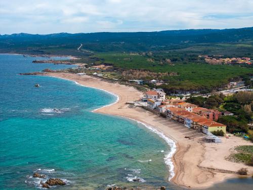 an aerial view of a beach with houses and the ocean at Relaxing Residence Baia dei Mirti B4 1 Bedroom Apartment Sleeps 4 -Bilo 4 in Vignola Mare