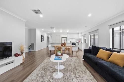 a living room with a couch and a table at The Alfredton - Spacious Ballarat Stay for Families in Alfredton