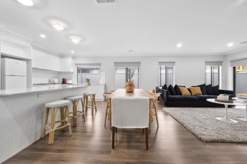 a kitchen and living room with a table and chairs at The Alfredton - Spacious Ballarat Stay for Families in Alfredton