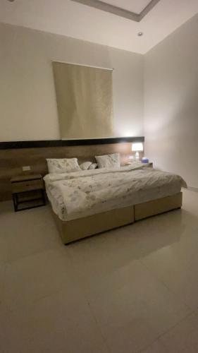 a bedroom with a bed in a white room at الدانه 2 in Hafr Al-Batin