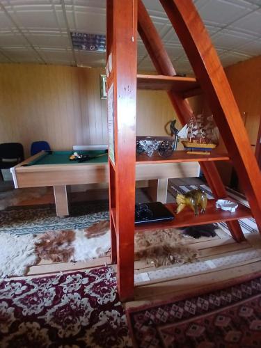 a bunk bed with a pool table in a room at Pensiune Colina Farm in Găgeni