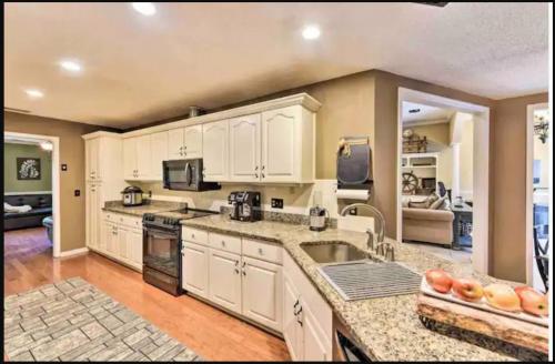 a kitchen with white cabinets and a counter top at Georgia's Nature Retreat On Old Mill Pond in Statesboro