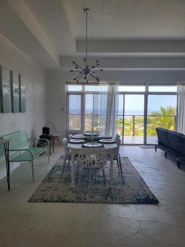 a dining room with a table and chairs in a living room at Diamond Villa in Brighton Village