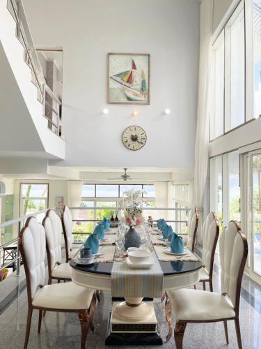 a dining room with a long table and chairs at Vipa Seaview Villa in Patong Beach