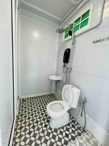 a small bathroom with a toilet in a trailer at British Granny's Cottage in Georgetown in Jelutong