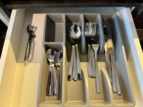 a tray filled with utensils on a table at HOM I Lujoso Depto 2D2B, Ñuñoa con Estacionamiento in Santiago