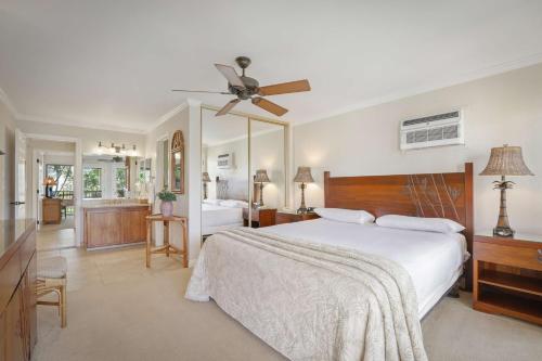 a bedroom with a bed and a ceiling fan at Aston Maui Hill in Wailea