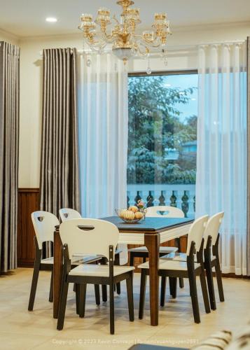 a dining room with a table and chairs and a window at Lưng Chừng House in Da Lat