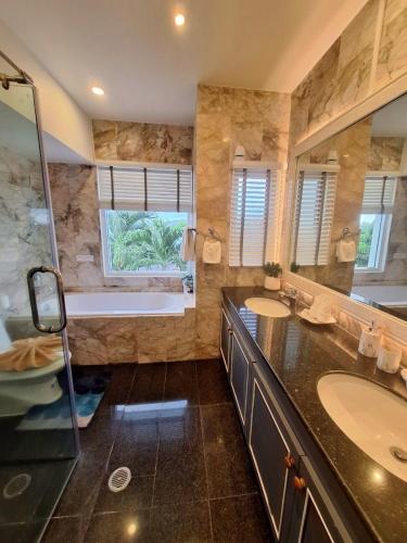 a large bathroom with two sinks and a tub at Vipa Seaview Villa in Patong Beach