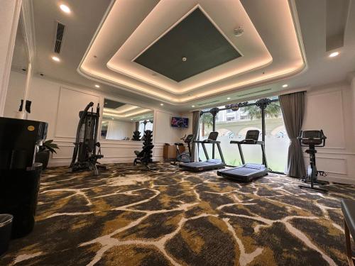 a gym with treadmills and exercise equipment in a room at Wyndham Garden Grandworld Phu Quoc in Phu Quoc