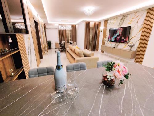 a bottle of wine on a table in a living room at Diamond Residence Qawra - Side Sea View in St. Paul's Bay