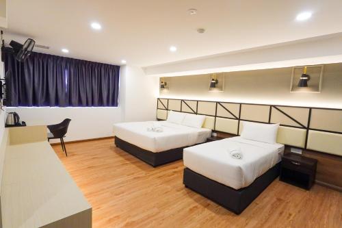 Postel nebo postele na pokoji v ubytování Merits Hotel Cameron Highlands