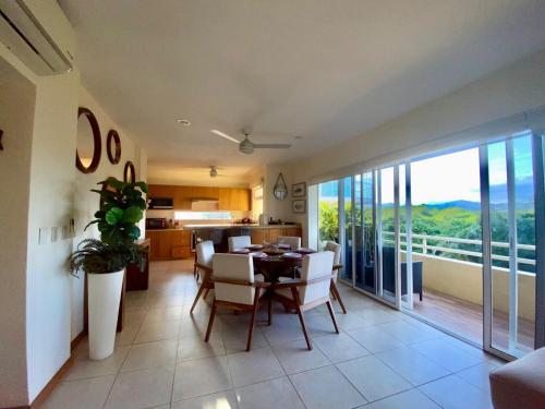 a kitchen and dining room with a table and chairs at Nuevo Vallarta flamingos beach en bahia de banderas in Nuevo Vallarta