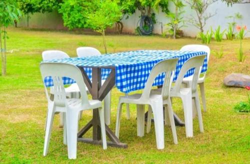 a blue and white table with white chairs around it at The Cinnamon Villa By Kings Bay in Negombo
