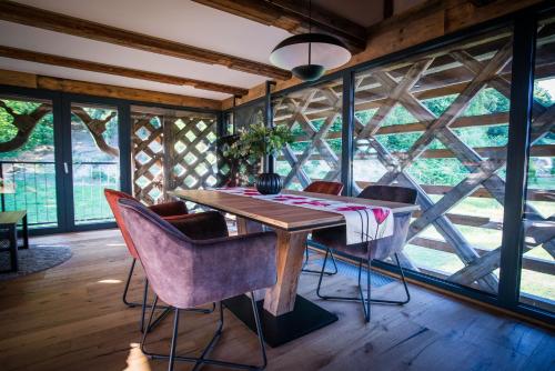 a dining room with a wooden table and chairs at Hayrack Skok Mozirje in Mozirje