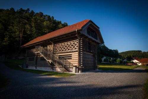 a log cabin with a staircase on the side of it at Hayrack Skok Mozirje in Mozirje