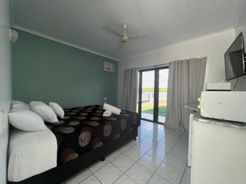 a bedroom with a bed and a television in a room at Lucinda Cove Resort in Lucinda