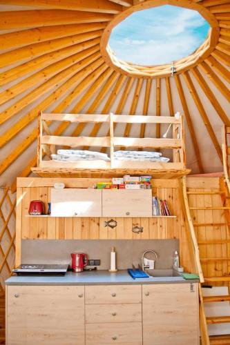 a room with a bed and a sink in a yurt at FORGLAMP in Bydgoszcz