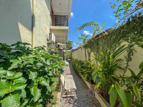 a garden corridor with plants next to a building at Wisma Anugerah Redpartner Near Masjid Zayed Solo in Bonorejo