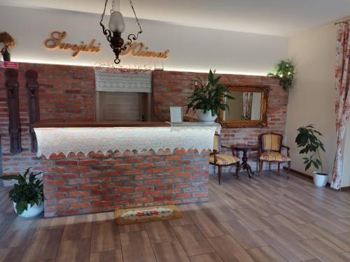 a living room with a brick wall and a fireplace at Swojski Klimat in Płońsk