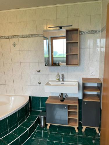 a bathroom with a sink and a bath tub at Appartement Natalie in Ried im Zillertal