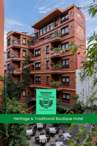 a large building with a sign in front of it at Dalai-La Boutique Hotel in Kathmandu