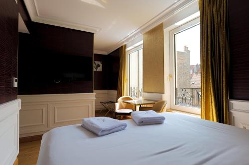 Postel nebo postele na pokoji v ubytování Hôtel Merveilleux Côté Mer