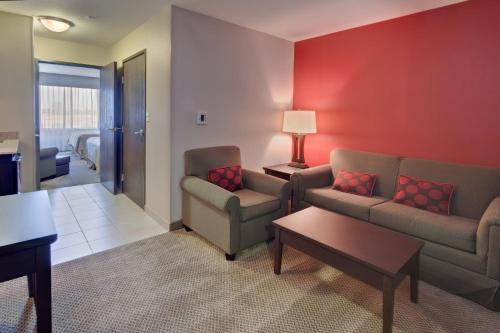 a living room with two couches and a table at Holiday Inn & Suites Bakersfield by IHG in Bakersfield