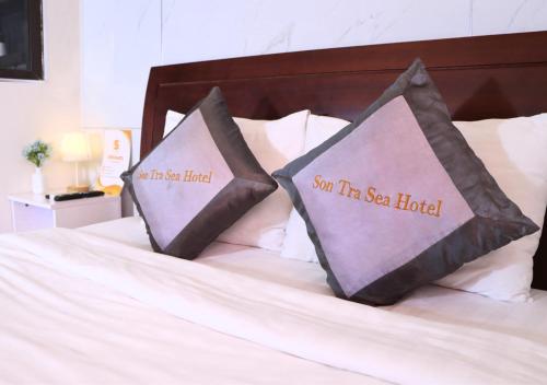 two pillows sitting on top of a bed at Sontra Sea Hotel in Da Nang