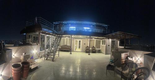 a house with a deck at night with lights at Riverfront Penthouse Studio with Spacious Terrace in Lucknow