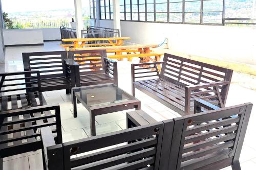 a group of benches and tables and a table at Urbanview The Halona near Jawa Timur Park 4 in Batu