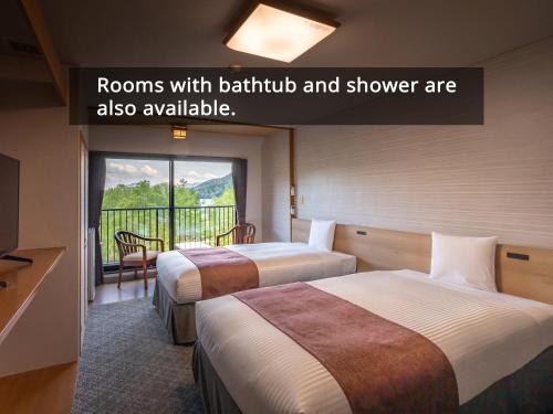 Postel nebo postele na pokoji v ubytování KAMENOI HOTEL Okunikko