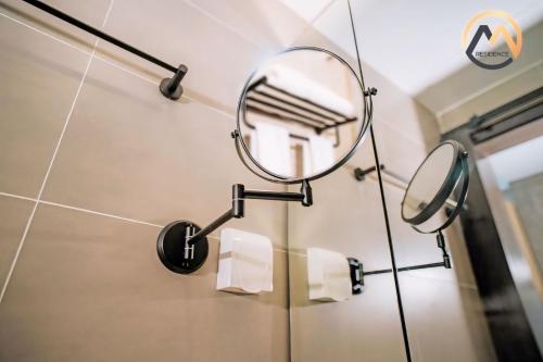 a bathroom with a mirror and toilet paper rolls at Hotel Serviced Condo Unique Infinity Pool with Mekong River View in Phnom Penh