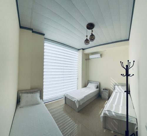 a bedroom with two beds and a window at MrShox Hostel 1 in Samarkand