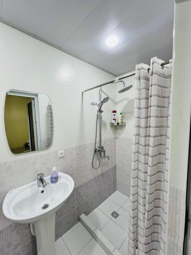 a bathroom with a sink and a shower at MrShox Hostel 1 in Samarkand