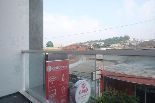 a view of a city from a window of a building at RedDoorz Syariah Near Simpang Lima Semarang in Jomblang