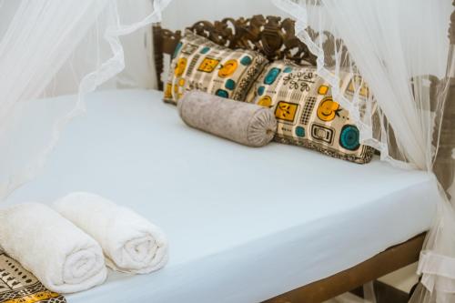 a bed in a room with towels and pillows at Royal Palace Mirissa in Mirissa