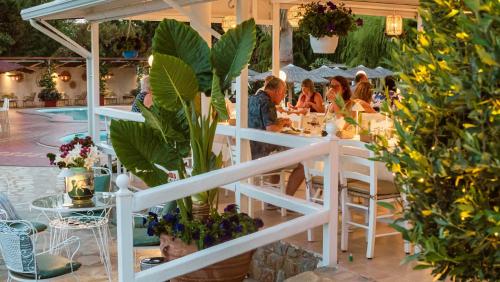 a group of people sitting at a table in a restaurant at Almira Hotel in Troulos