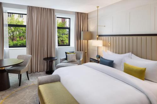 a hotel room with a large bed and a desk at The Alexander, a Luxury Collection Hotel, Yerevan in Yerevan