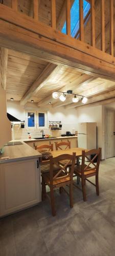 a large kitchen with a wooden table and chairs at Chrisanthi's Cottage in Mougkelátika