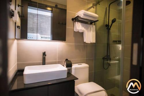 a bathroom with a toilet and a sink and a mirror at Hotel Serviced Condo Unique Infinity Pool with Mekong River View in Phnom Penh
