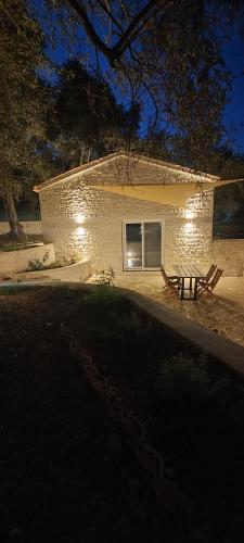 a bench in front of a house at night at Chrisanthi's Cottage in Mougkelátika