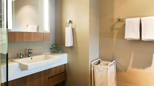 a bathroom with a sink and a mirror at Ra Premiere Simatupang in Jakarta