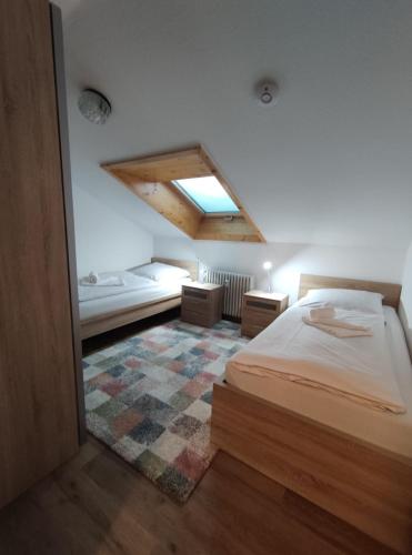a bedroom with a large bed and a rug at Haus Obermaiselstein in Obermaiselstein
