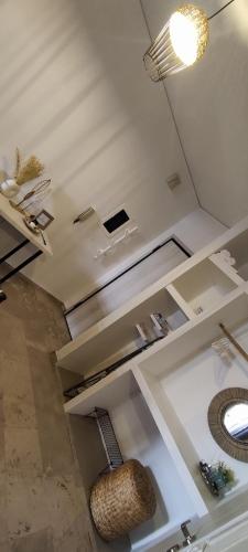 a white room with a sink and a mirror at Seaside Akrata's House in Paralía Akrátas