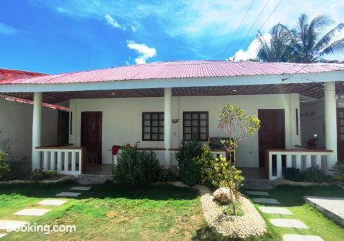 a small white house with a red roof at Bluewaves Resort - Basdaku by Hiverooms in Moalboal
