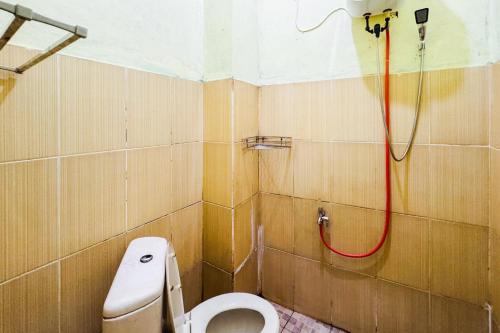 a bathroom with a toilet and a shower at Penginapan Dison RedPartner in Bekasi