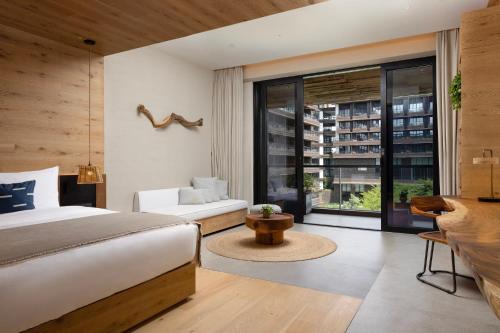 a bedroom with a bed and a large window at 1 Hotel Haitang Bay, Sanya in Sanya