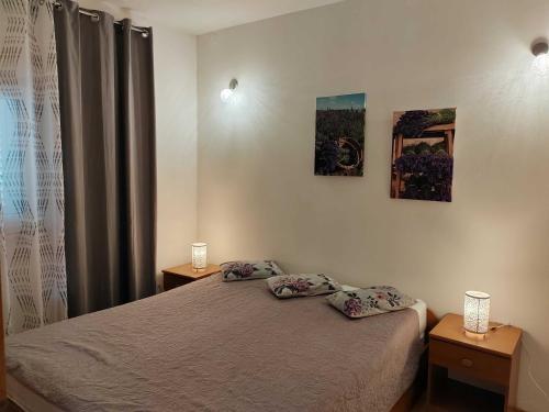 a bedroom with a bed with two pillows on it at Villa Stella in Rogoznica